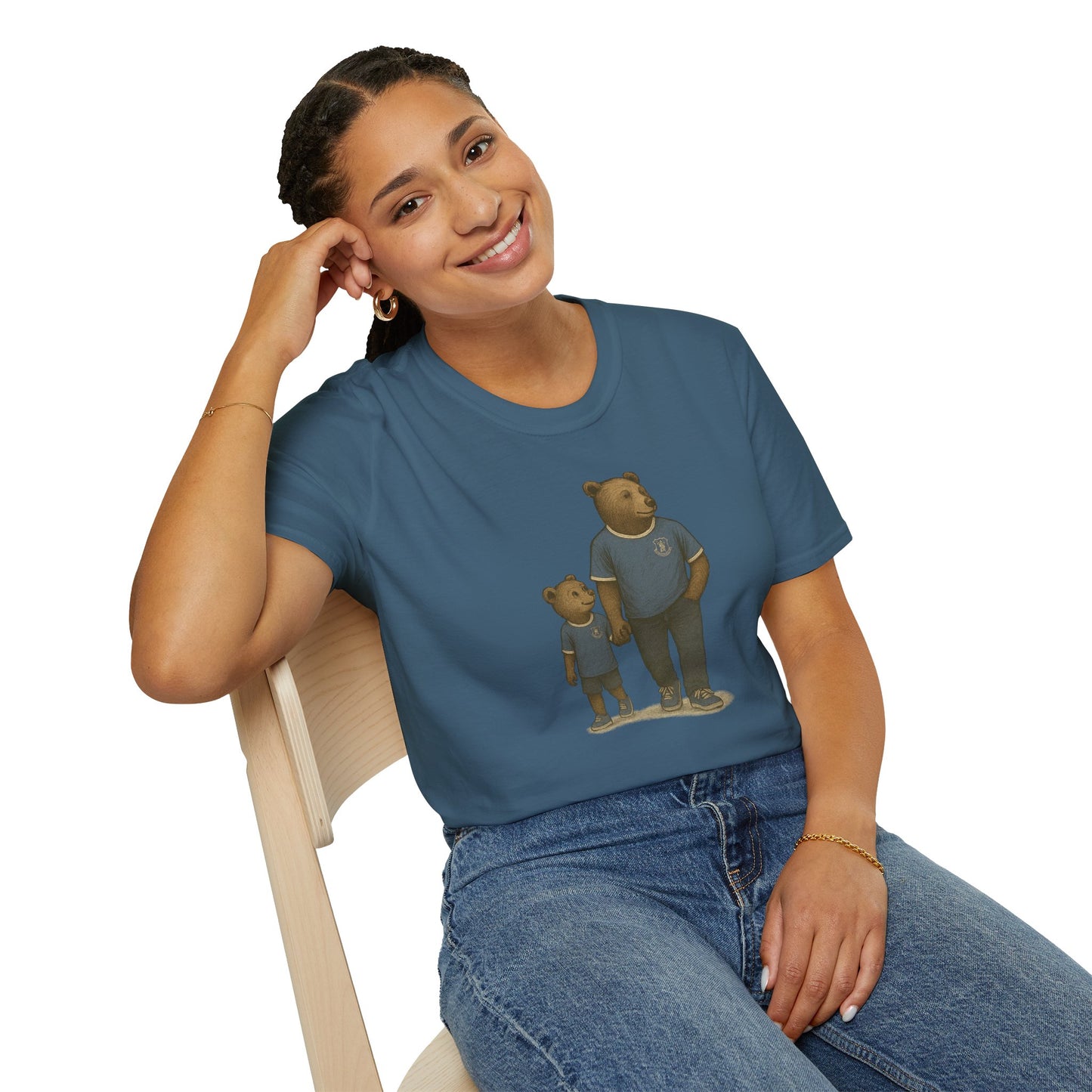 Smiling woman wearing blue t-shirt with bear family graphic sitting on wooden chair