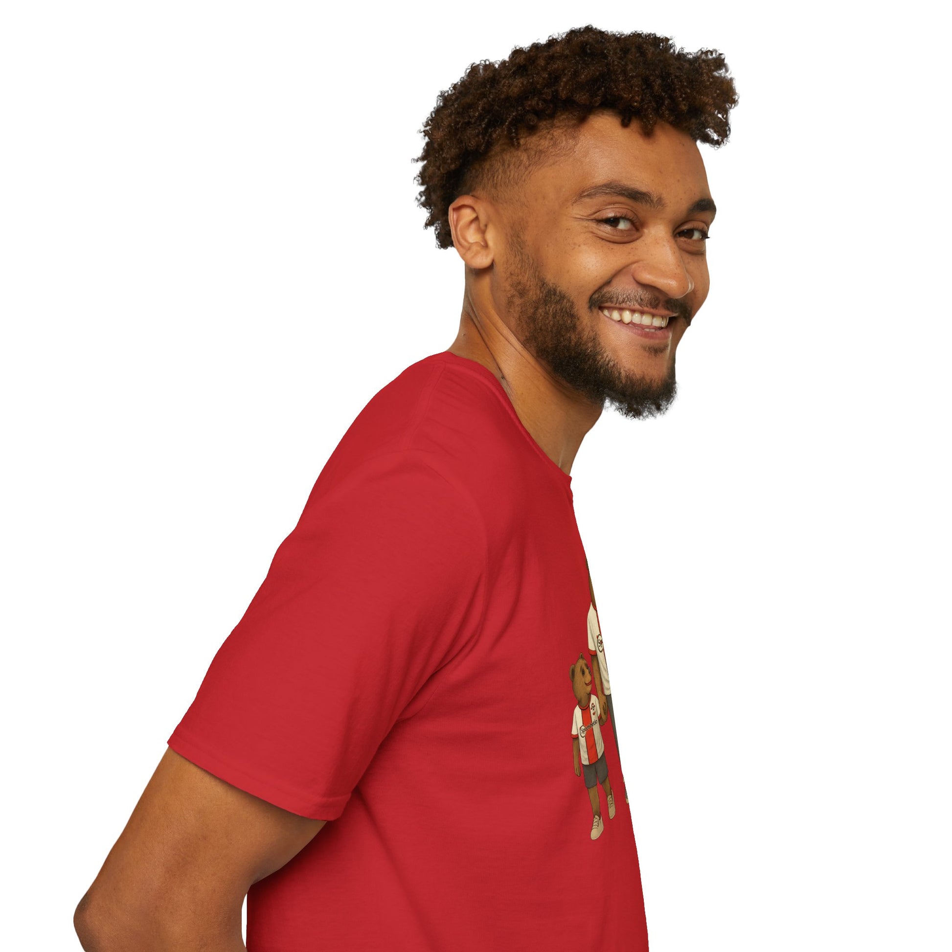 Smiling man with curly hair wearing red graphic t-shirt against white background