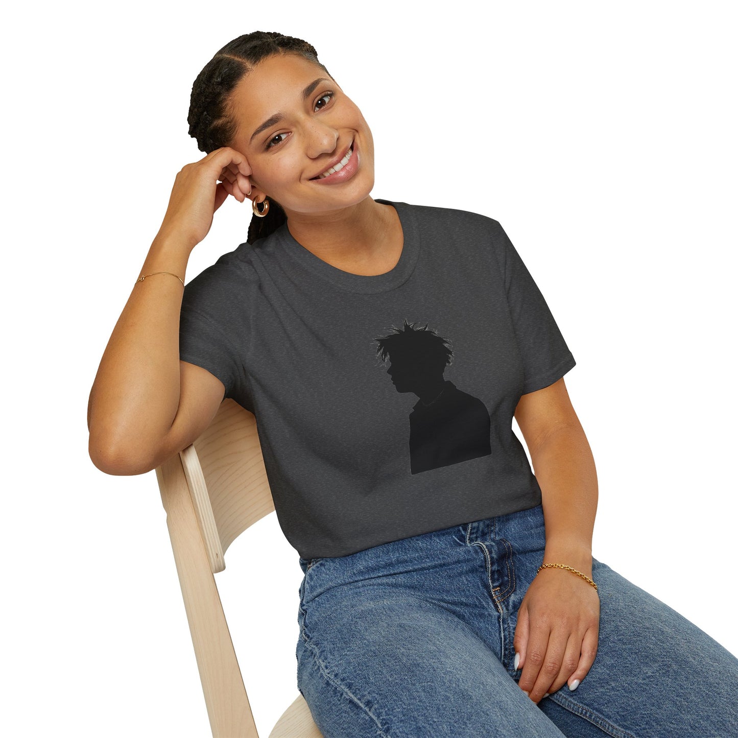 Smiling woman sitting on wooden chair wearing dark grey t-shirt with black silhouette graphic and blue jeans