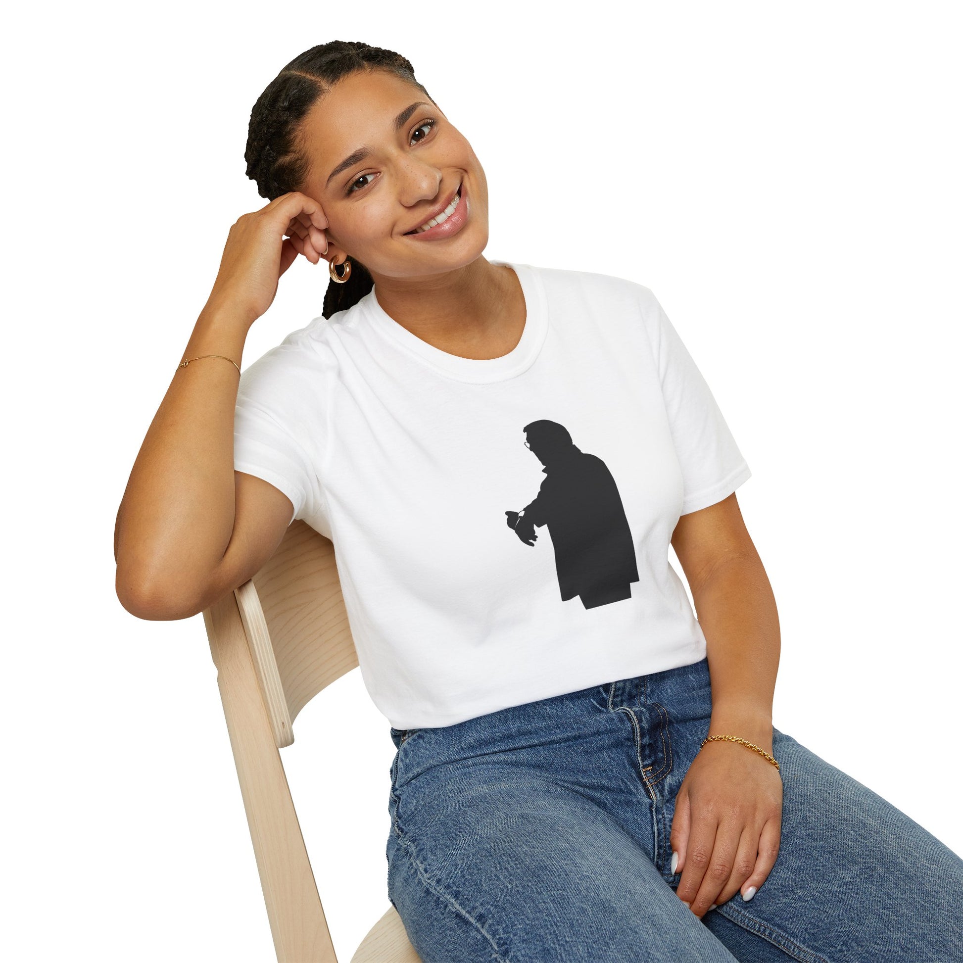 Smiling woman wearing white t-shirt with black silhouette print sitting on wooden chair against white background