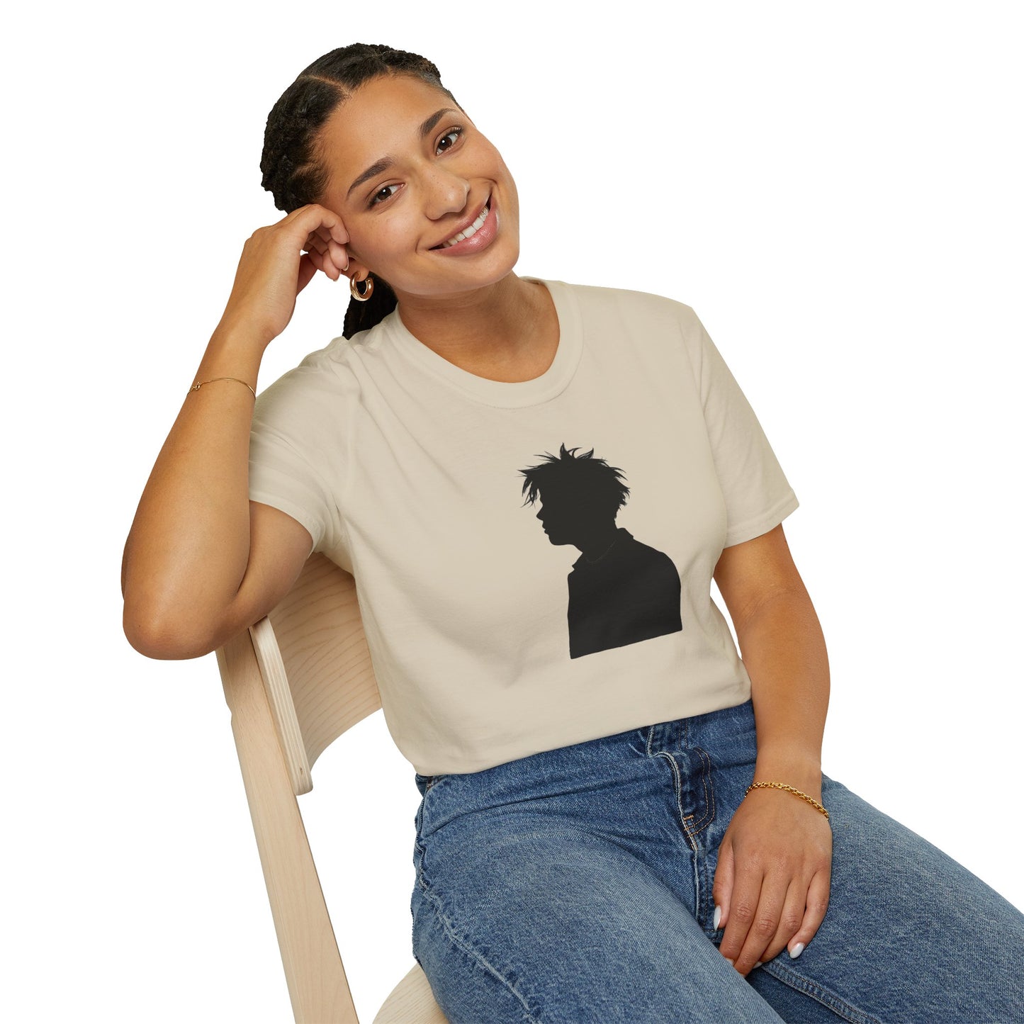 Smiling woman wearing beige t-shirt with black silhouette graphic, sitting on wooden chair in casual outfit