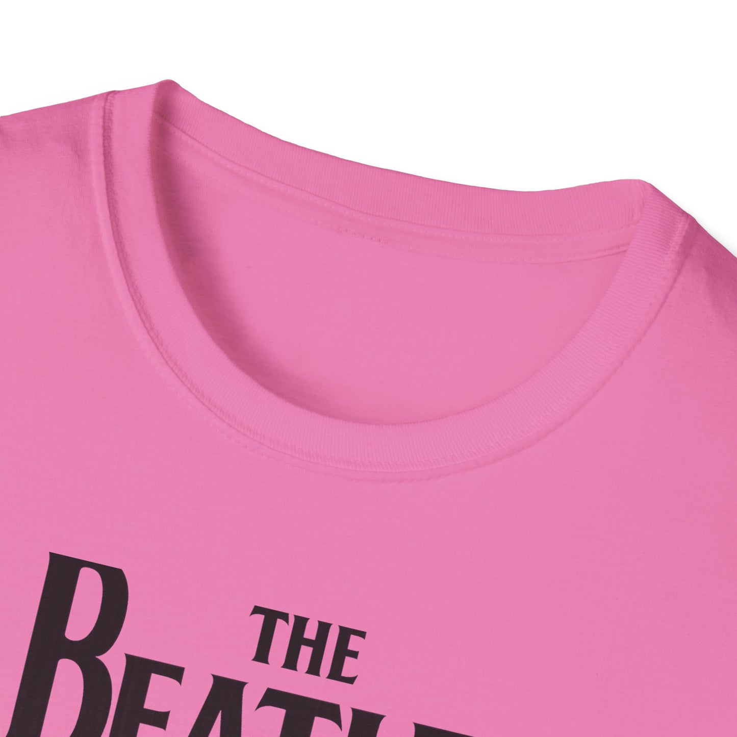 Close-up of a pink t-shirt with 'The Beatles' text.
