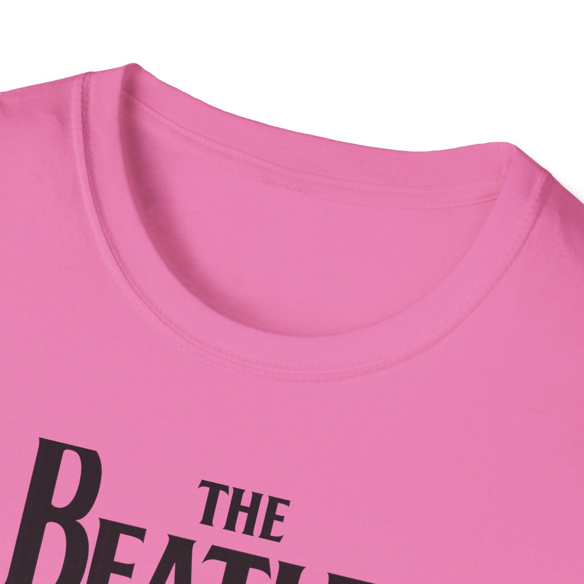 Close-up of a pink t-shirt with 'The Beatles' text.
