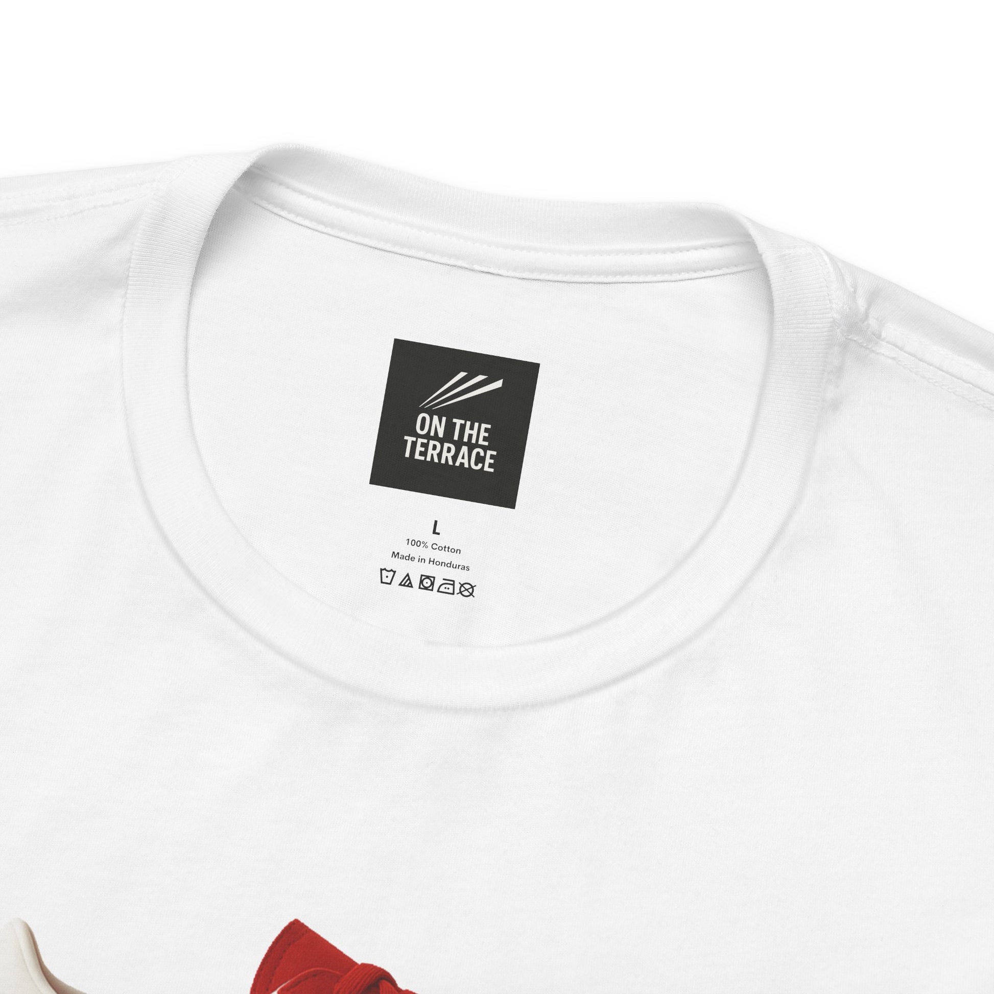 Close-up of white cotton T-shirt neckline with On The Terrace brand label and care instructions
