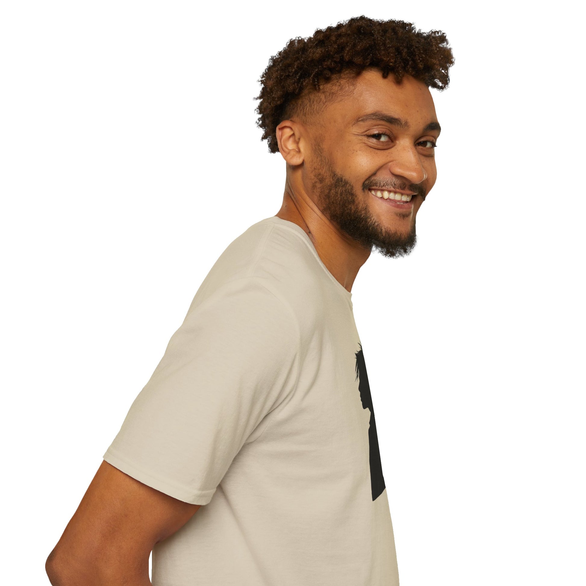 Smiling man with curly hair wearing beige T-shirt with black silhouette design on white background