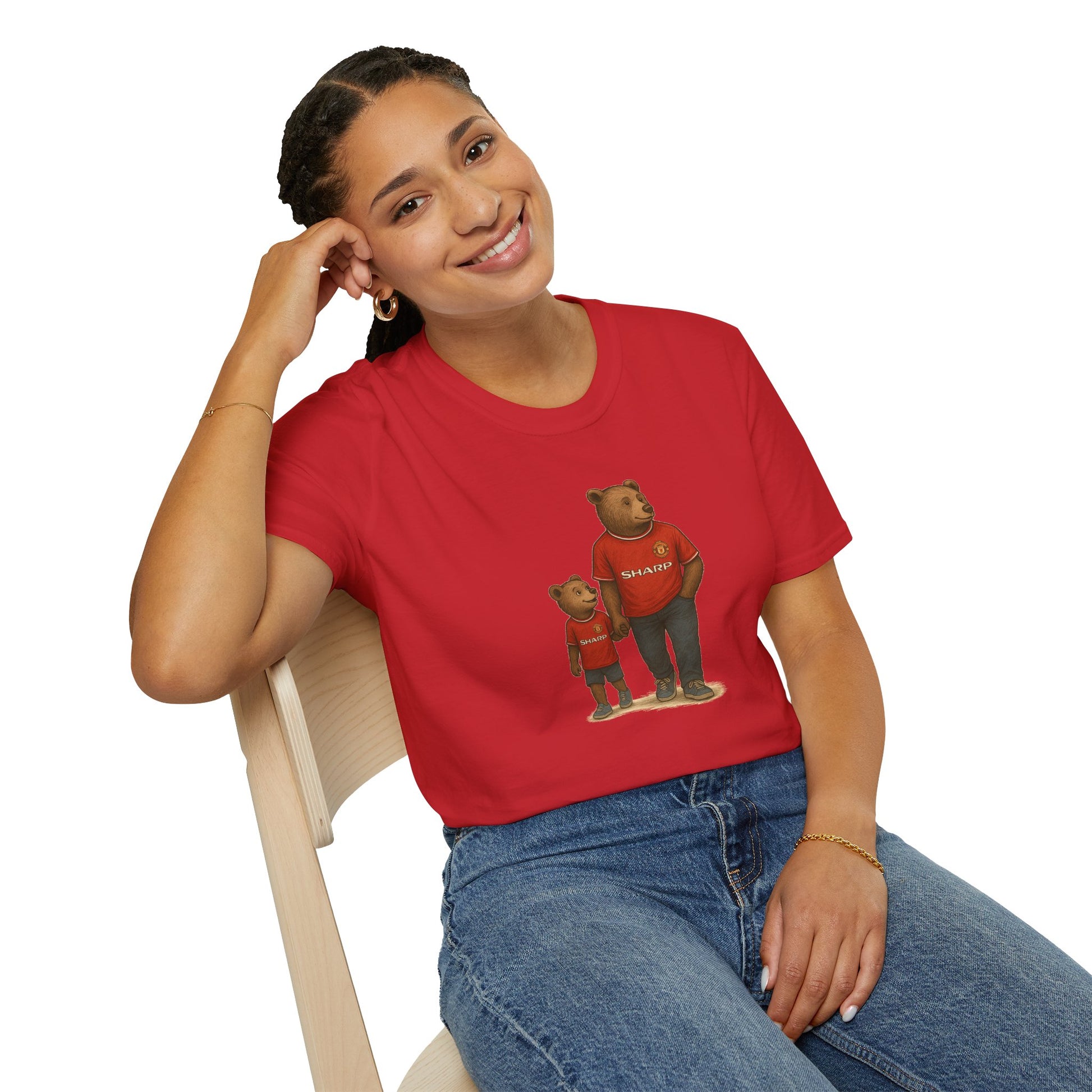 Smiling woman wearing a red T-shirt with bears in matching red shirts sitting on wooden chair