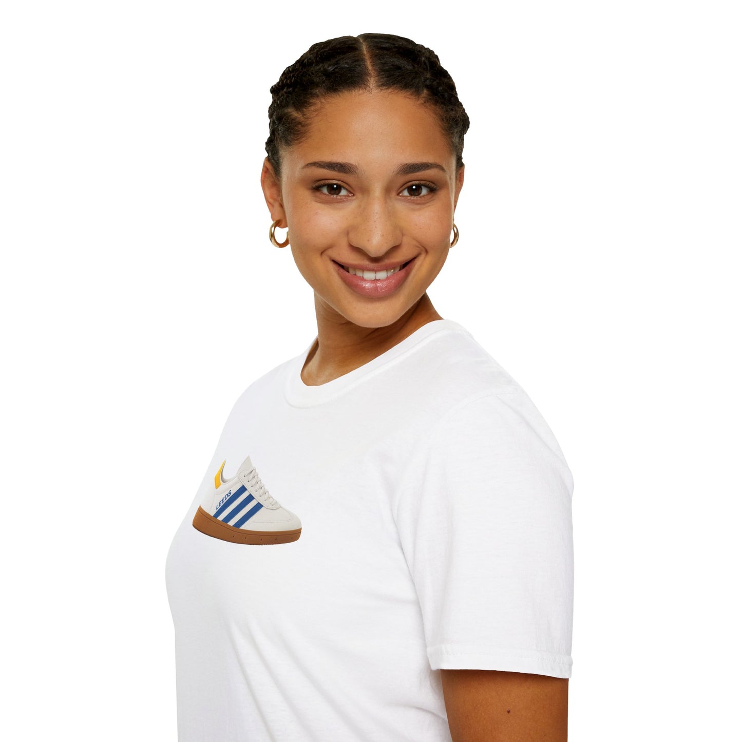 Smiling woman wearing white T-shirt with graphic sneaker print and gold hoop earrings on white background