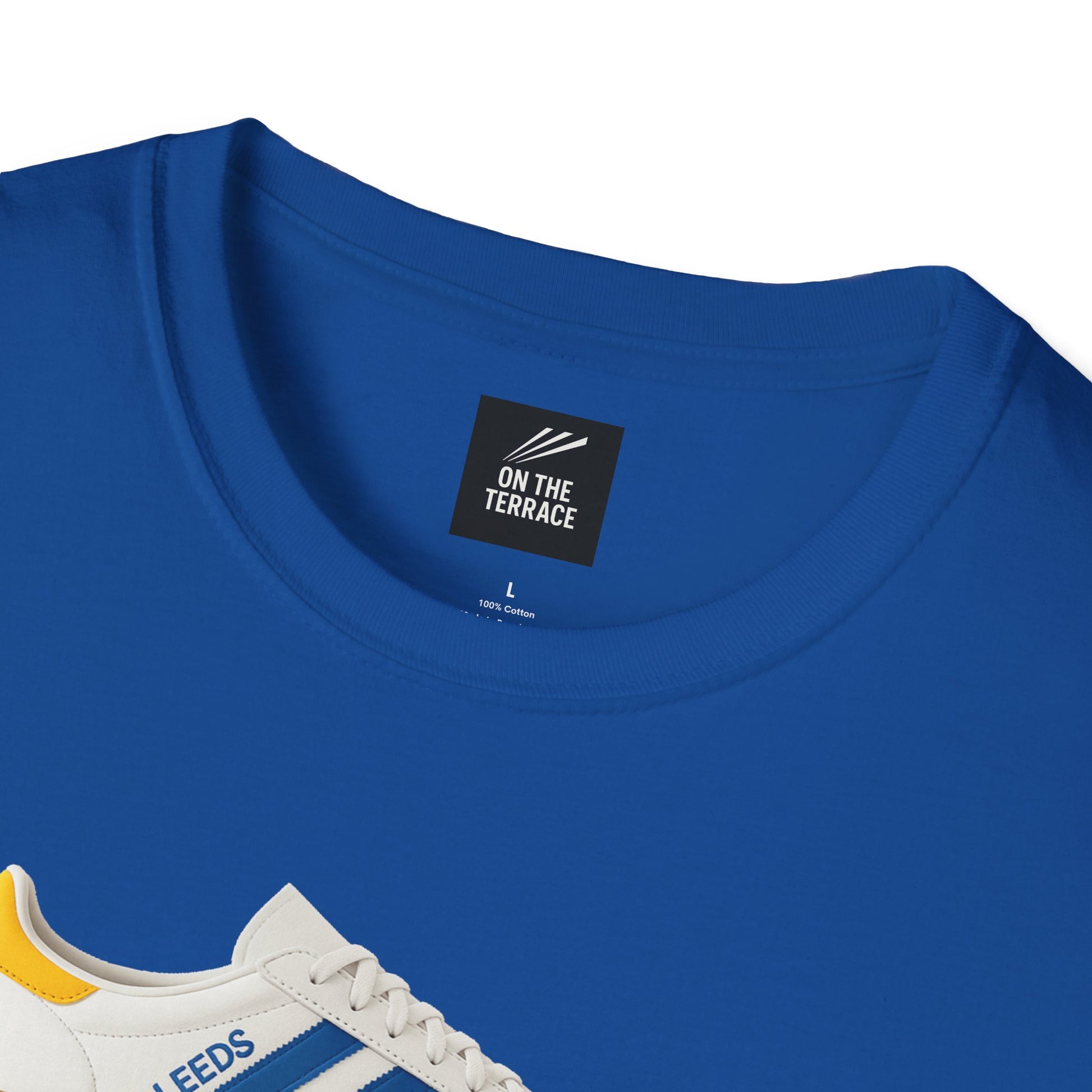 Blue cotton t-shirt with On The Terrace label and partial sneaker print in white, blue, and yellow