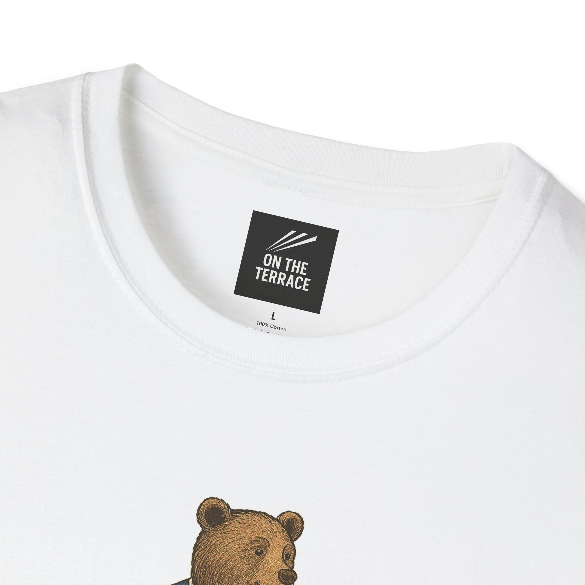 Close-up of white cotton T-shirt neckline with black label reading 'ON THE TERRACE' and partial bear graphic